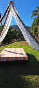 a bed with a mosquito net on top of a field at Estância Villa Ventura in Socorro
