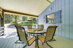 a patio with a table and chairs on a deck at Peaceful Maggie Valley Vacation Rental with Fire Pit in Maggie Valley