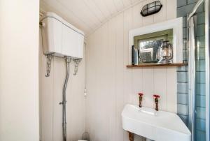a bathroom with a sink and a mirror at Oak + Stars Hideaway in Holmfirth