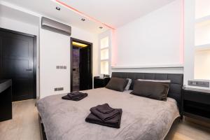 a bedroom with a bed with two towels on it at Stylish 2 bedroomed apartment Gzira (UPDATED PICS) in Il-Gżira