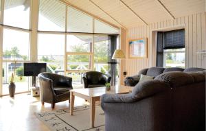 a living room with a couch and chairs and a table at Beautiful Home In Hemmet With 4 Bedrooms, Sauna And Wifi in Falen