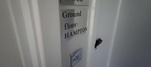 a door with a sign that reads ground floor evacuation at Luxury 5BD Suite Guest House in London