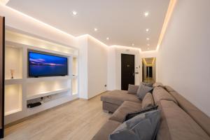 a living room with a couch and a flat screen tv at Stylish 2 bedroomed apartment Gzira (UPDATED PICS) in Il-Gżira