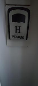 a black and white toaster hanging on a wall at Luxury 5BD Suite Guest House in London