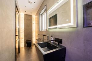 a bathroom with a sink and a mirror at Stylish 2 bedroomed apartment Gzira (UPDATED PICS) in Il-Gżira +28 photos