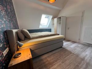a small bedroom with a bed and a table at Astrid's Appartements in Winterberg