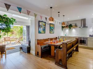 a kitchen with a table and a dining room at Yew Tree House in Chideock