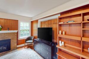 a living room with a television and a fireplace at Potter Place in Eugene