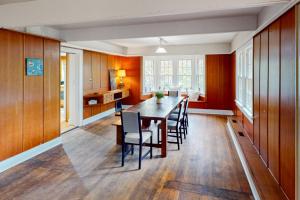 a kitchen and dining room with a wooden table and chairs at Potter Place in Eugene