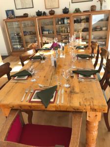 a wooden table with glasses and napkins on it at The Old School, Kingussie in Kingussie +14 photos