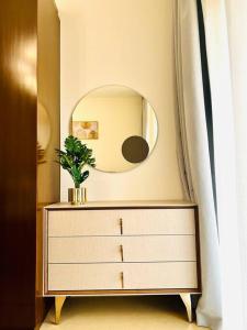 a dresser with a mirror on top of it at one bedroom Modern Apartment Muscat Bay in Muscat