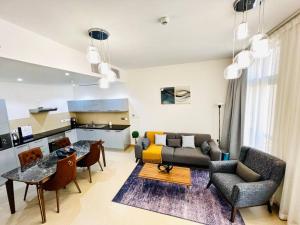 a living room with a couch and a table at one bedroom Modern Apartment Muscat Bay in Muscat