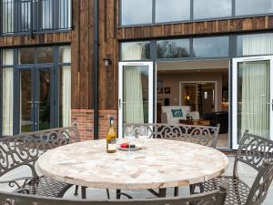 a table with a bottle of wine on a patio at The Haybarn in Ferndown