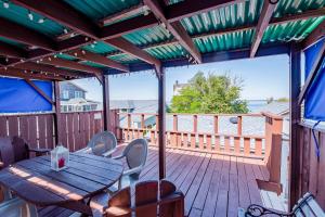 un patio con mesa y sillas en una terraza en The Blue Parrot Guest House, en Ocean Beach