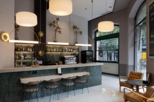 a bar in a restaurant with stools at Catalonia Eixample 1864 in Barcelona +45 photos