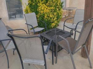 a table and chairs sitting on a patio at Be Our Guest-Shared Home Tampa in Palmdale