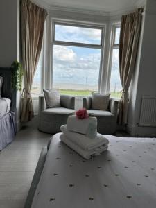 a living room with a couch and a window at The Beach House in Lowestoft