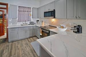 a kitchen with white cabinets and a counter top at Scotland Villa 2 in St Thomas