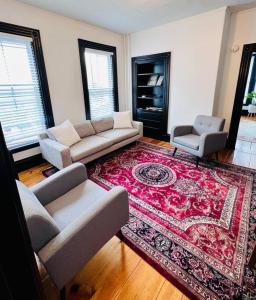 a living room with a couch and a rug at Centrally located East End & off-street parking in Portland