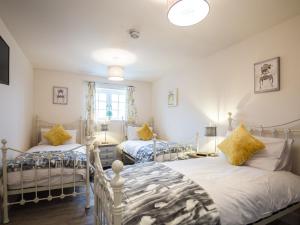 a bedroom with two beds and a window at Field View - Ukc2304 in Wainfleet All Saints