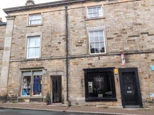 a brick building with windows and doors on a street at Royal Next View in Carnforth