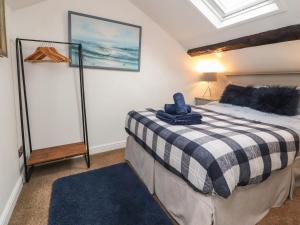 a bedroom with a bed with a black and white blanket at Royal Next View in Carnforth