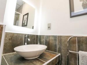 a bathroom with a sink and a mirror at Royal Barn View in Carnforth
