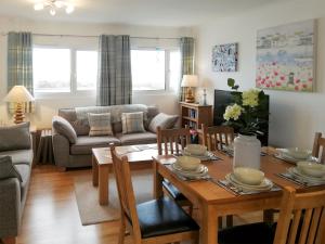 a living room with a table and a couch at Trevone in St Merryn