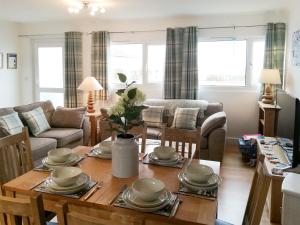 a living room with a table with dishes on it at Trevone in St Merryn
