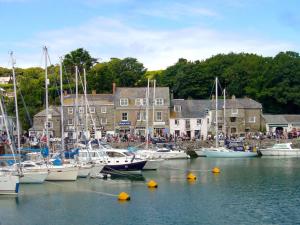 a group of boats are docked in a harbor at Trevone in St Merryn