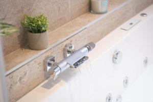 a bathroom sink with a chrome faucet at L'instant léger - Centre ville in Chambéry