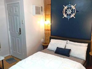 a bedroom with a bed with a nautical sign on the wall at Urban Chique Condo in Marilao Bulacan near PhilippineArena in Marilao