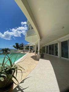 a house with a swimming pool and a patio at Grand Case Palace in Grand Case