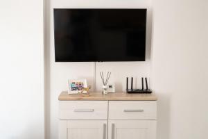 a flat screen tv hanging on a white wall at Transylvanian Valley in Sibiu