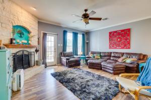 a living room with a couch and a fireplace at Spacious Hutto Retreat with Large Private Backyard in Hutto