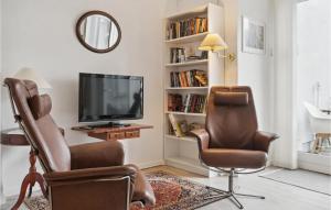 a living room with two chairs and a television at 1 Bedroom Nice Apartment In Stege in Stege