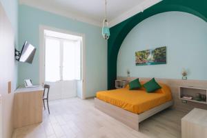 a bedroom with an orange bed and a green wall at Garden View Sorrento in Sorrento