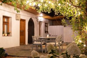 a patio with a table and chairs and a fence at Transylvanian Valley in Sibiu