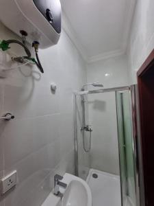 a small bathroom with a shower and a toilet at Lekki FootPrint, Lekki Phase1 in Lekki