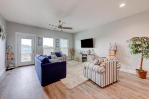 a living room with two couches and a tv at Beach Life in Port Aransas