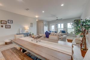 a dining room with a table and a living room at Beach Life in Port Aransas