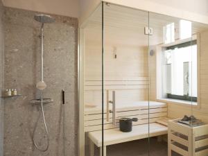 a bathroom with a shower with a glass door at OSTKÜSTE - Villa Steigel Design Apartments in Ahlbeck +87 photos