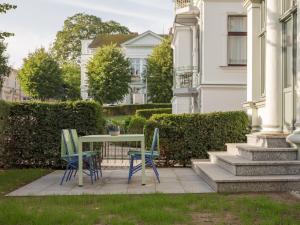 a table and chairs in front of a house at OSTKÜSTE - Villa Steigel Design Apartments in Ahlbeck