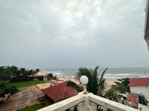 a view of the beach from the balcony of a resort at Hotel Salty Waves Baga in Baga