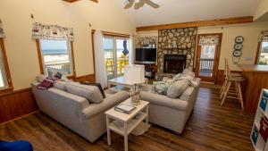 a living room with two couches and a fireplace at OCEANFRONT, 4-wheel drive area, Wild Horses, Ocean Views! 4x1662, Dolphin Watch in Corolla