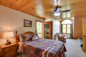 a bedroom with a bed and a ceiling fan at Grand Ellijay Cabin with Mountain Views and Pool Table in Ellijay