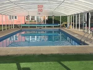 a swimming pool with an open canopy and a swimming pool at Henrys Barn - Ukc3168 in Walpole