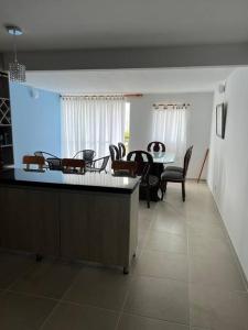 a kitchen and dining room with a table and chairs at Apartamento completo 3 habitaciones in Neiva