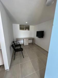 TV a/nebo společenská místnost v ubytování Tiziano apartamento 504