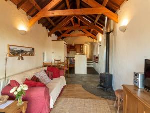 a living room with a couch and a stove at The Coach House in Mathry